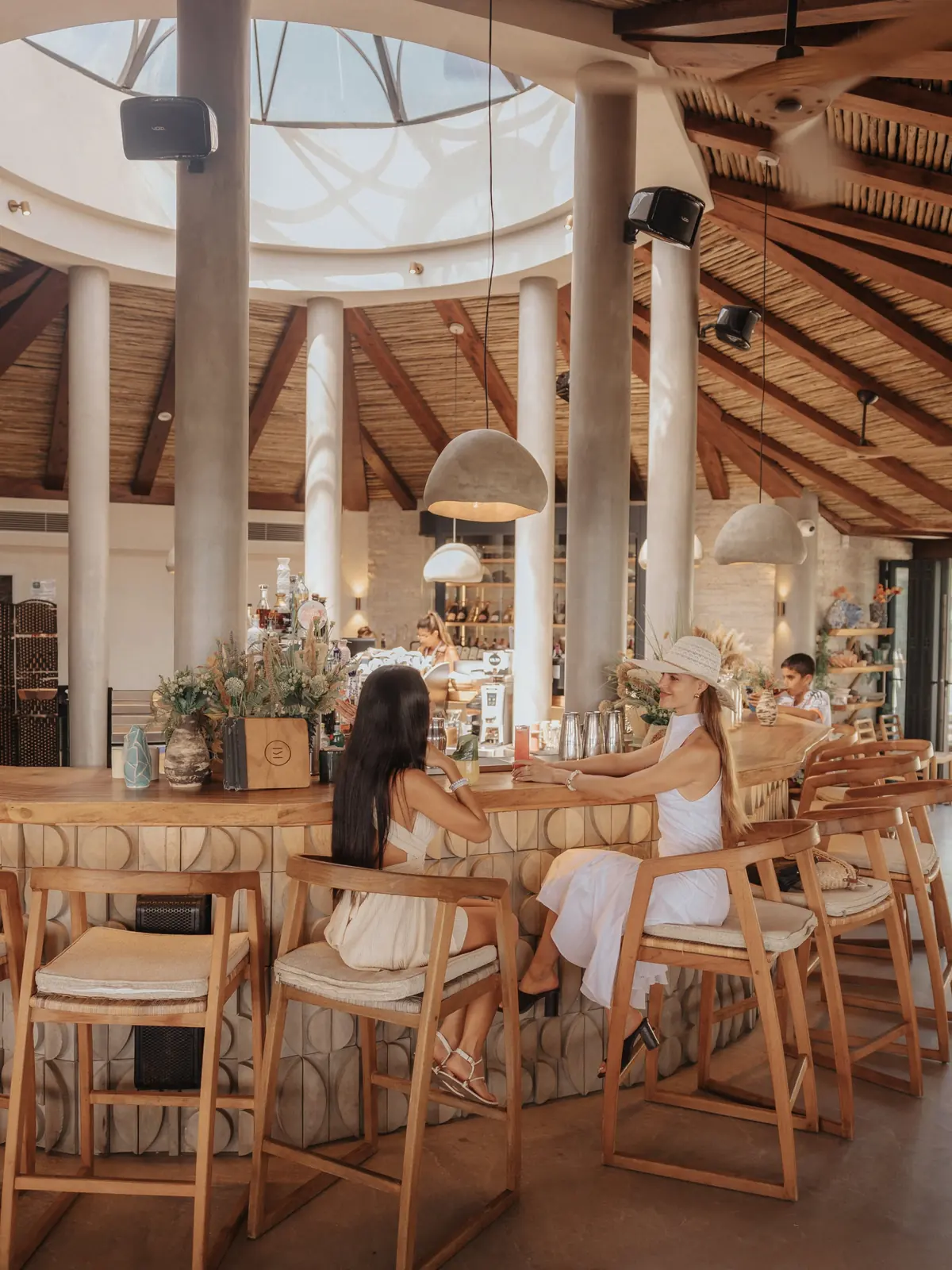 The circular bar beneath a domed reed and timber roof, open to the sky