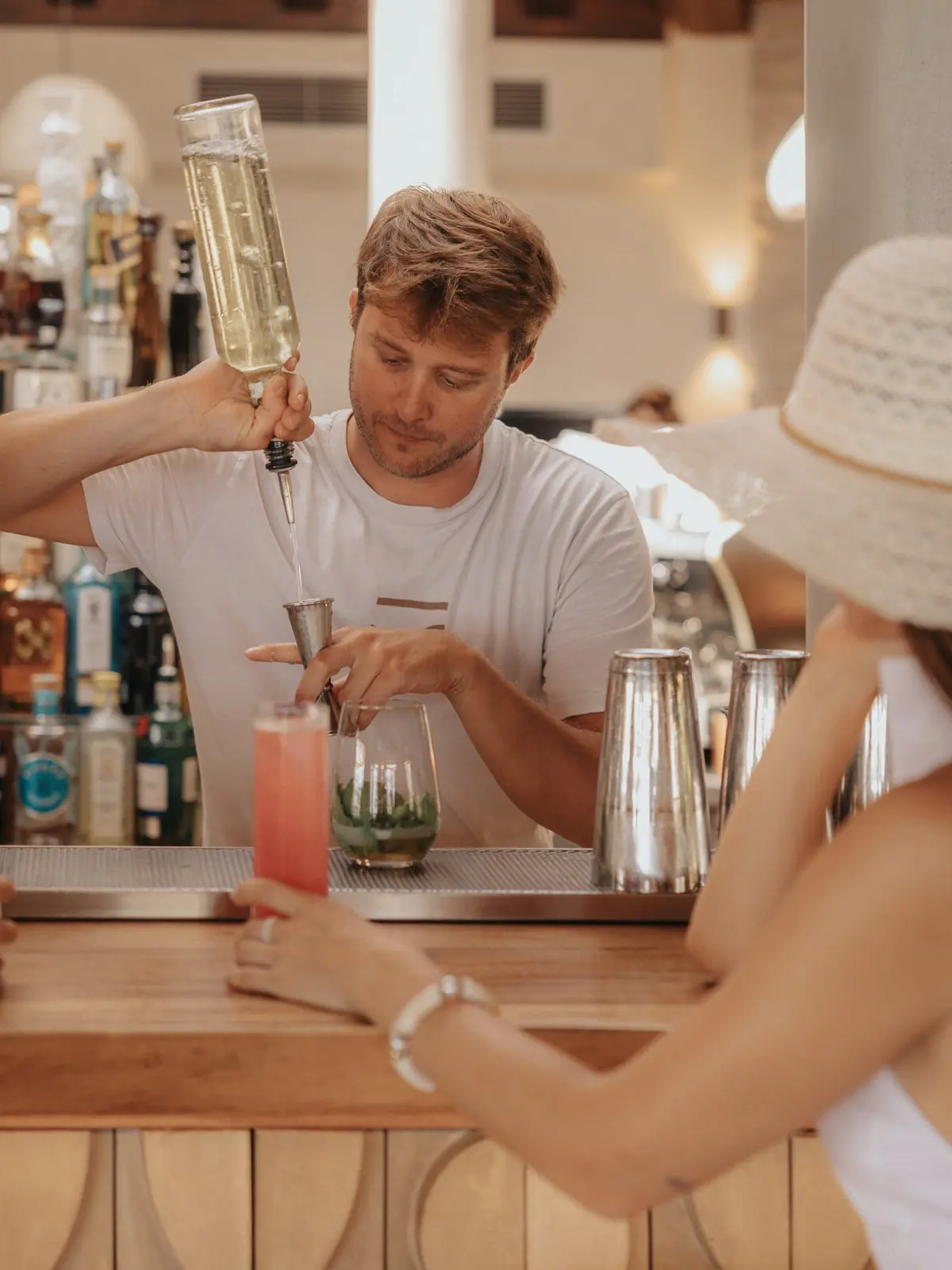 A bartender pouring at the bar
