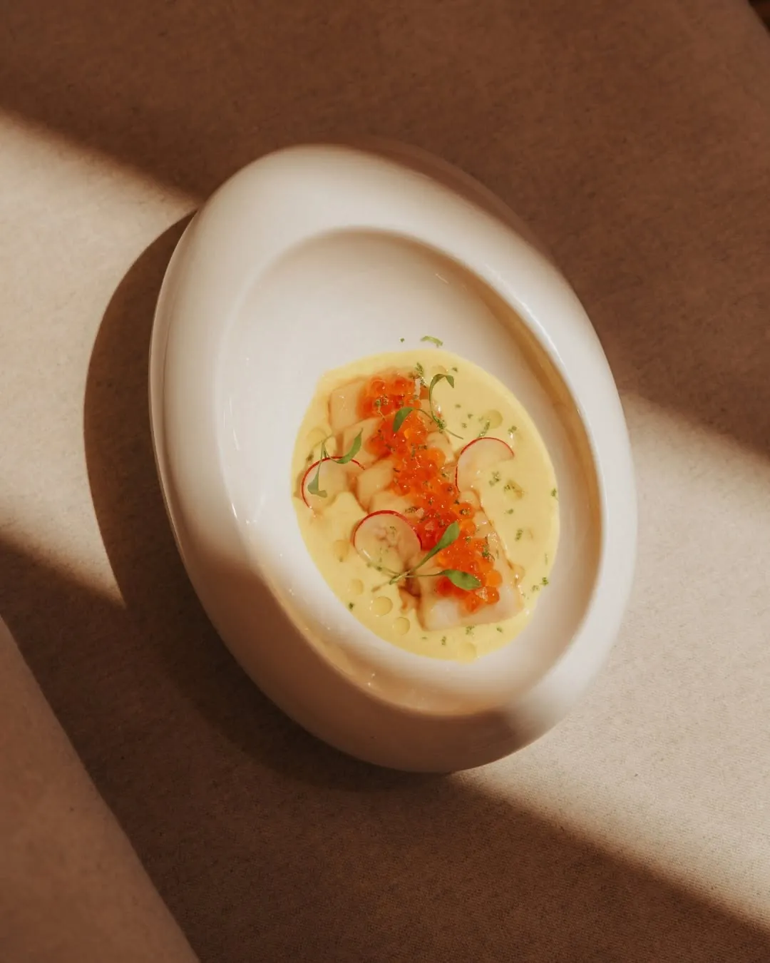 Ceviche served in a white ceramic oval dish