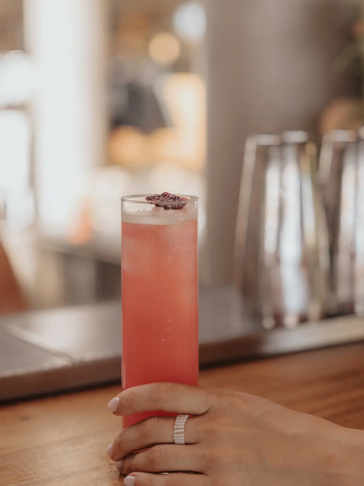 A tall cocktail on the timber bar
