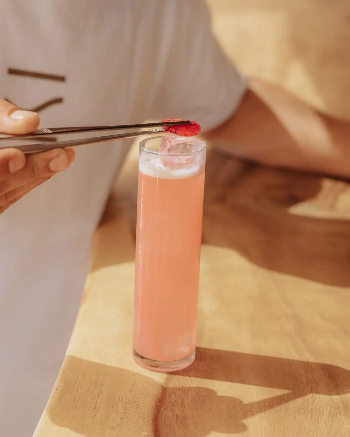 Finishing a cocktail with tweezers