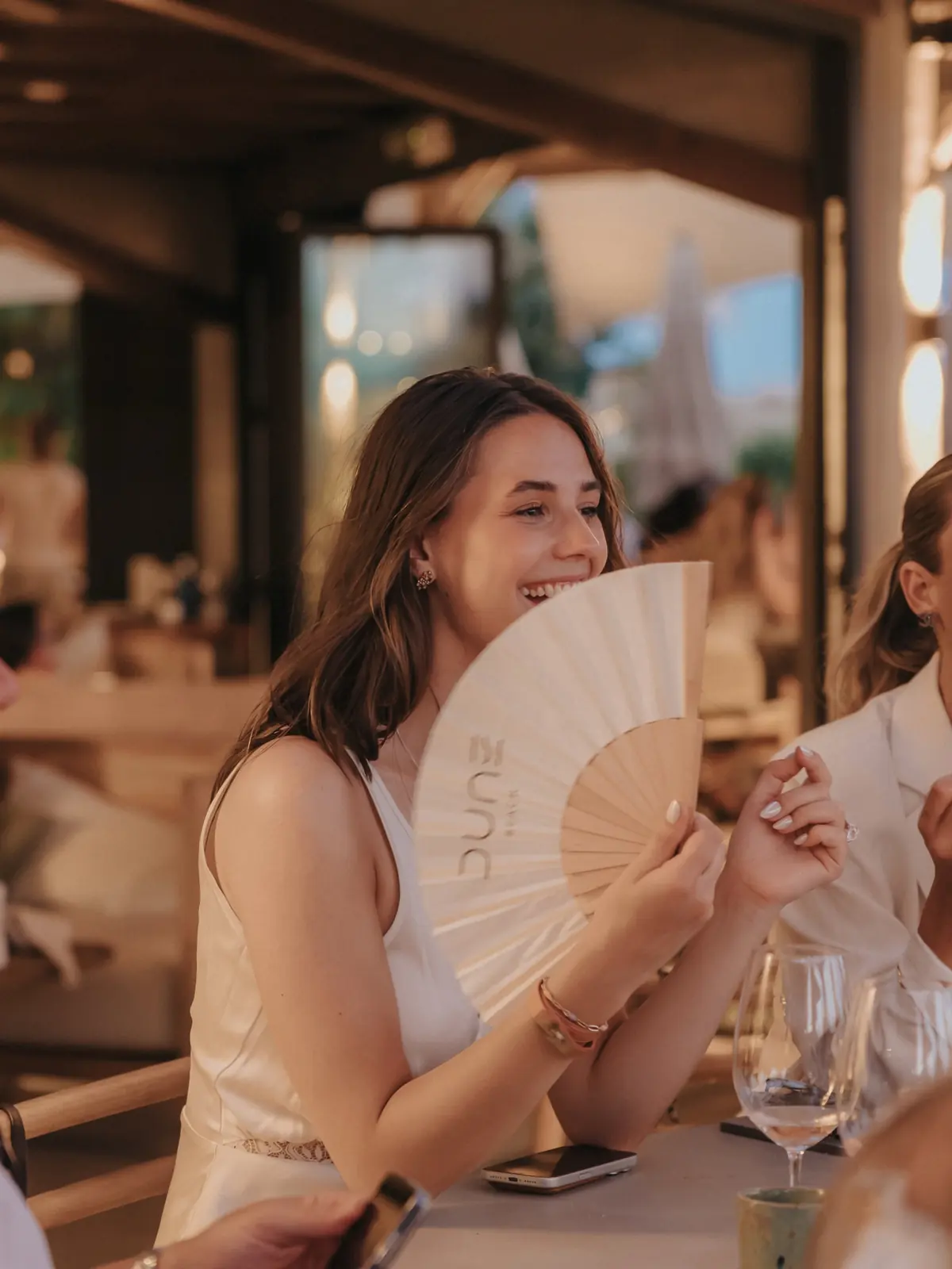 A guest laughing behind a Dune fan
