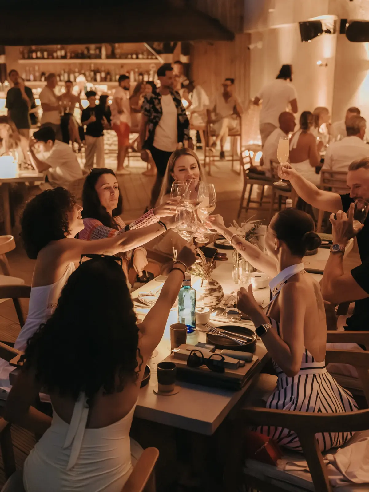 A toast around a long table at dinner